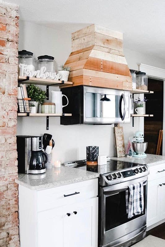 Small kitchen corner with white cabinets, quartz countertops, black accent and open shelvings