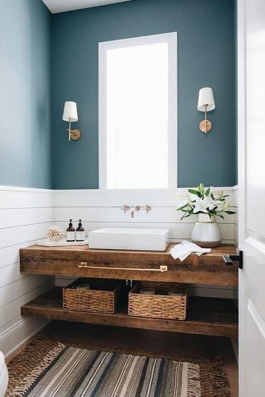 Reclaimed wood floating sink vanity paired with shiplap and blue walls