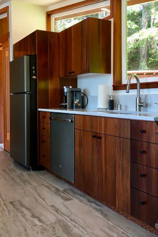 Recycled Materials Cabinets with white countertop and stainless steel appliances 