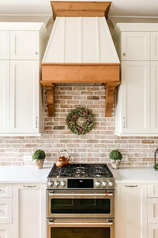 Red Brick Backsplash Paired with Shiplap and bright white cabinets