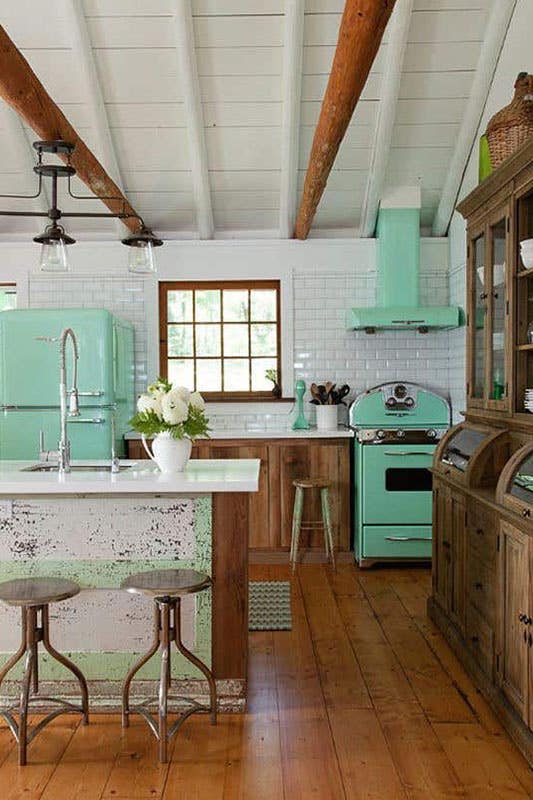 Retro kitchen design paired with wooden cabinets, Bright color appliances, and silver hardware