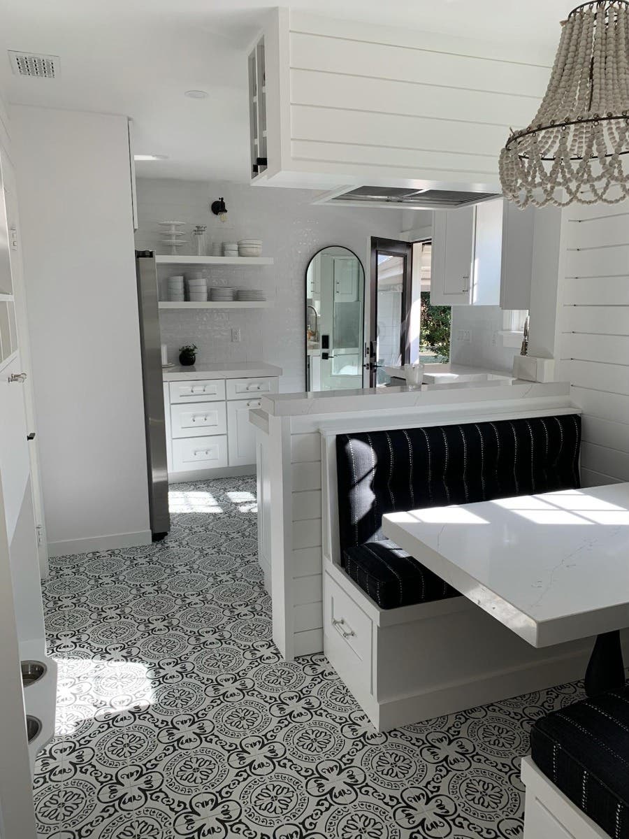 stunning white kitchen with black color seating area and open shelves decor 