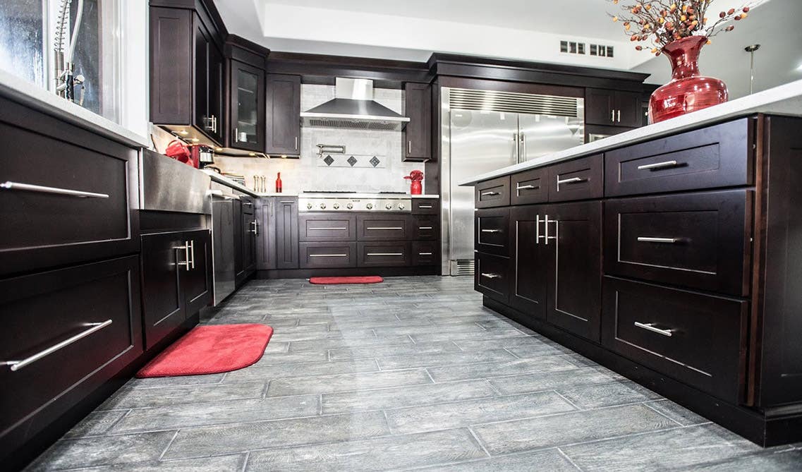 Kitchen design with Brown Cabinets and Grey Flooring