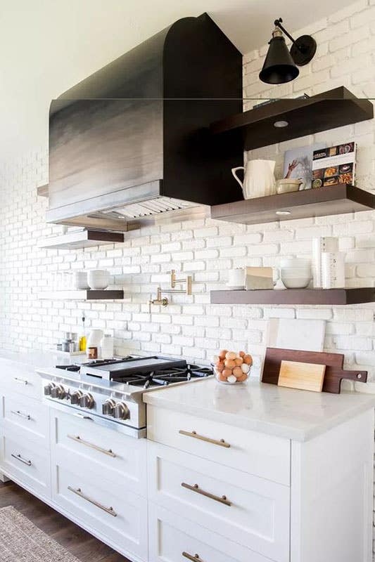 Rustic White Brick Backsplash with white shaker cabinets and Floating brown shelves