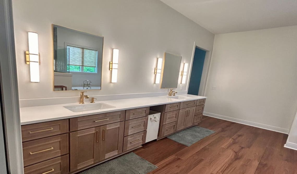 Natural wood bathroom vanity paired with wall-mounted fixtures