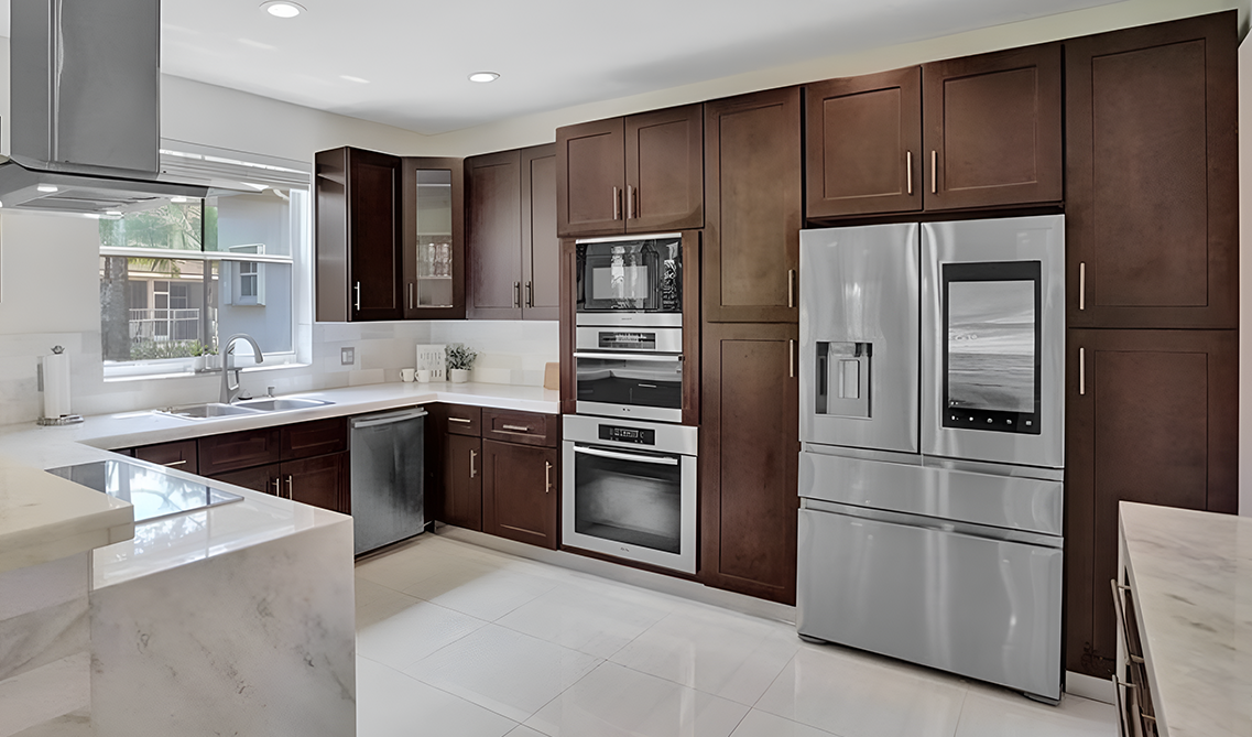 Shaker espresso kitchen cabinets paired with marble countertop and stainless steel appliances 