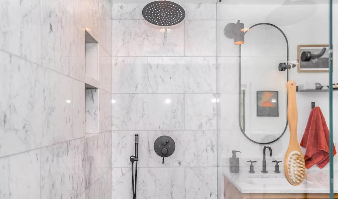 Bathroom shower with matt black fitting and factures and marble tiles