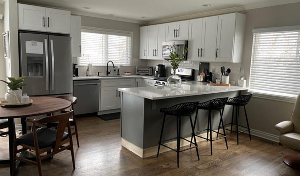 Stylish Black And White Kitchen with peninsula and black kitchen fixture