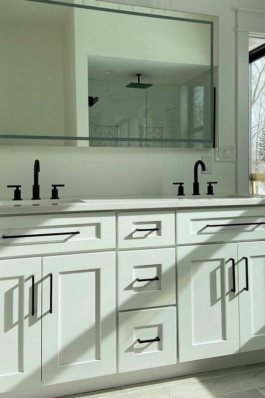 Shaker white cabinets with black hardware, fixture and Mirror 