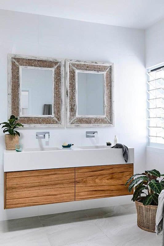 Sleek bathroom design features floating sink vanity with countertops and mirrors 