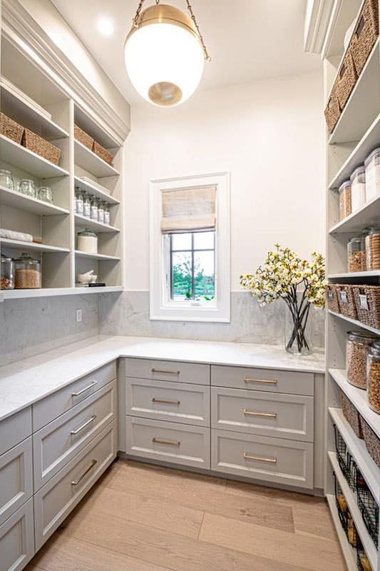 white kitchen pantry with base cabinets, gold hardware and open shelves 