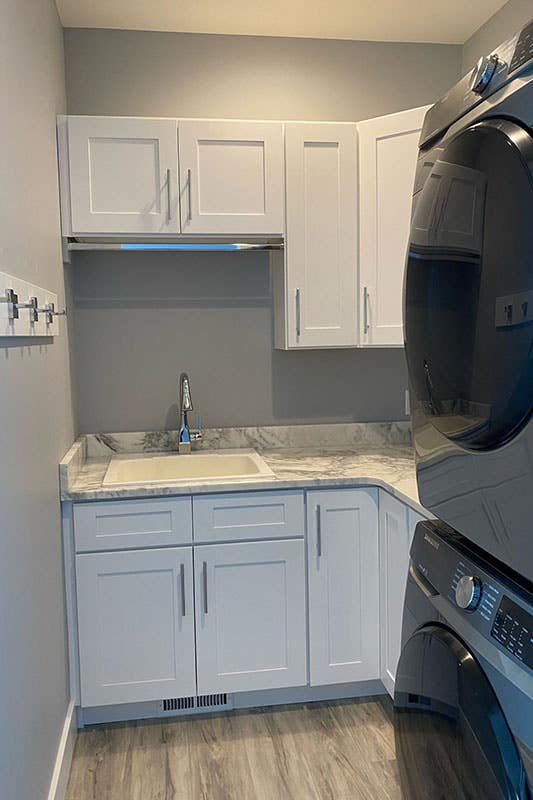 Small Laundry Room with white cabinets and washer and dryer