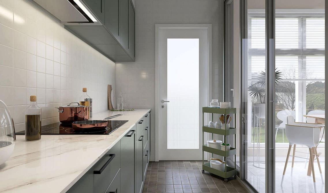 Single wall kitchen with sage green cabinets, black hardware, white marble countertop, cabinet light, a door to backyard