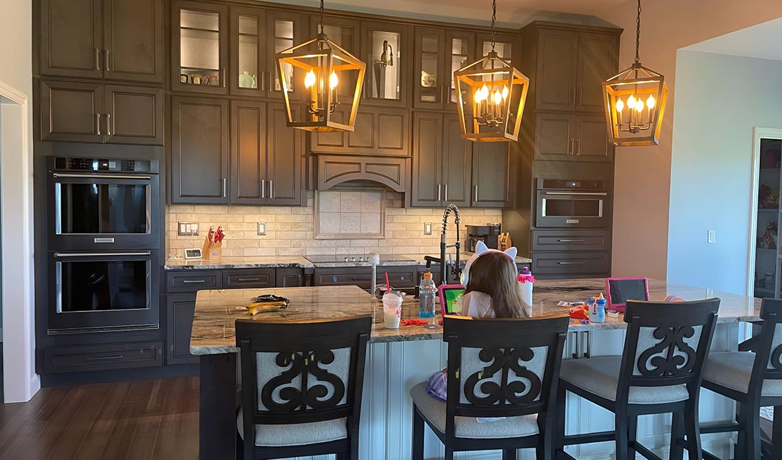 Solid Wood Cabinets paired quartz countertop and pendent lights over island