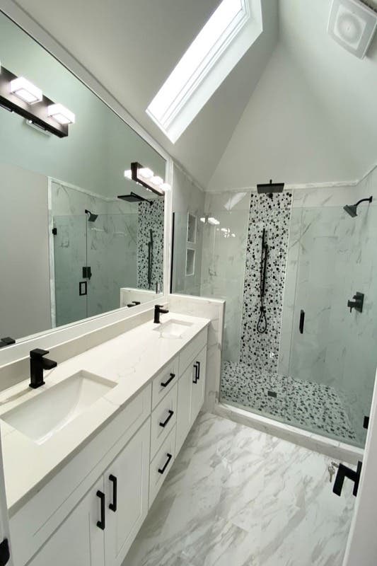Bathroom design with white cabinets and matt black fixture, separate shower area with natural stone tiles