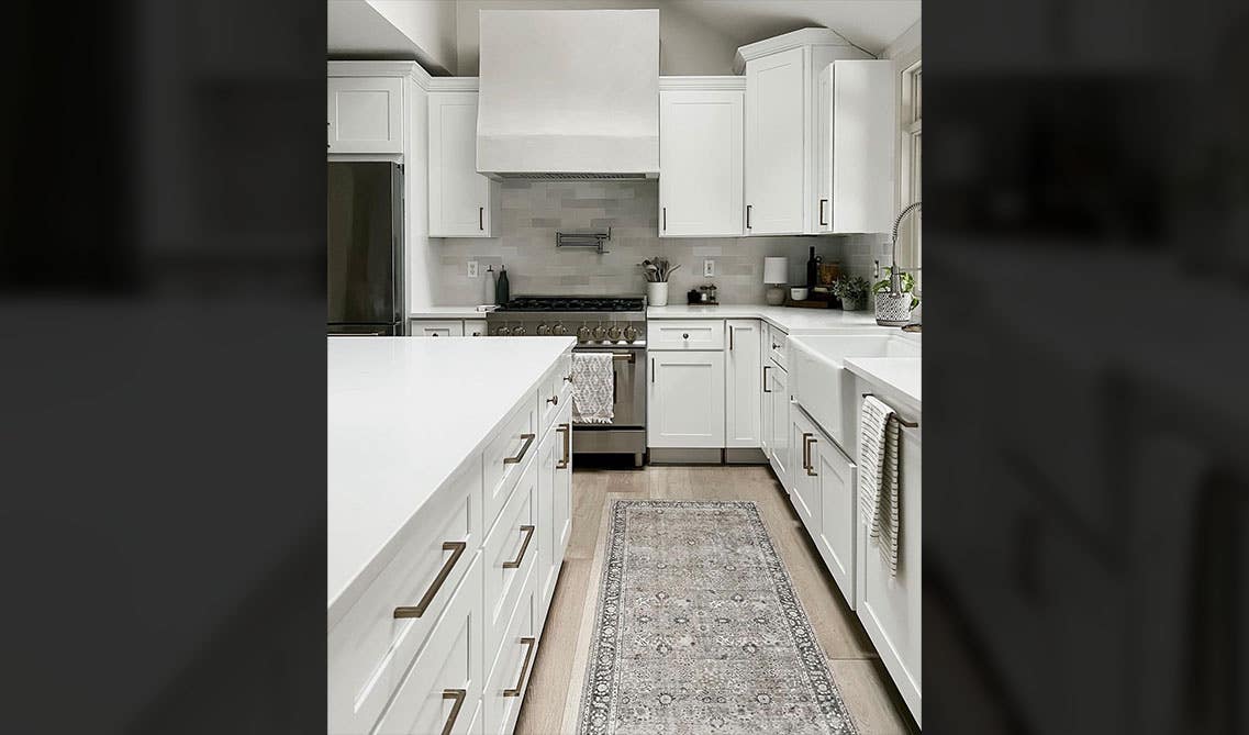 Staggered white Cabinets with metal hardware 