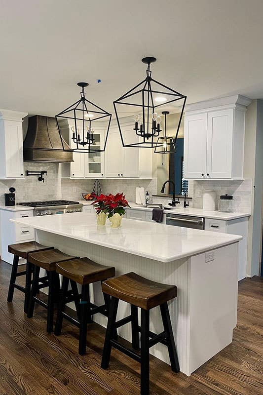 L shape kitchen with small island and statement pendent lighting 