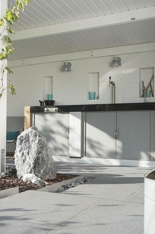 Gray storage cabinet in outdoor kitchen