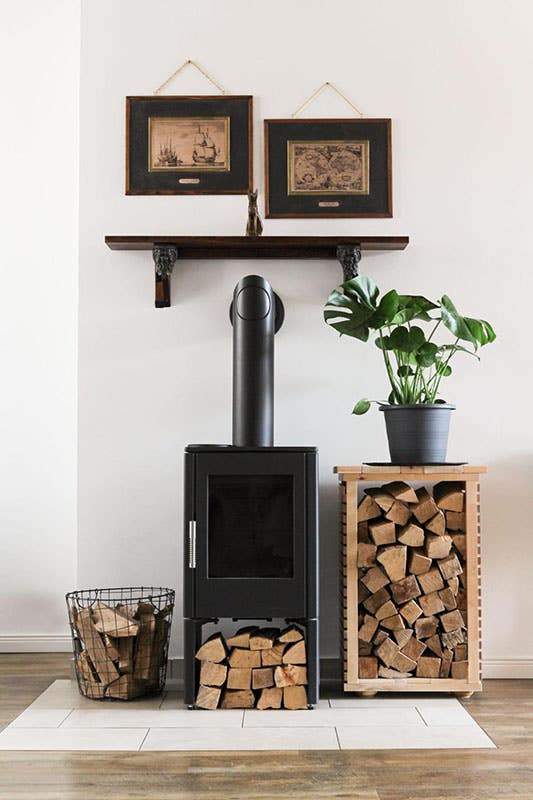 modern fireplace with firewood rack and storage basket