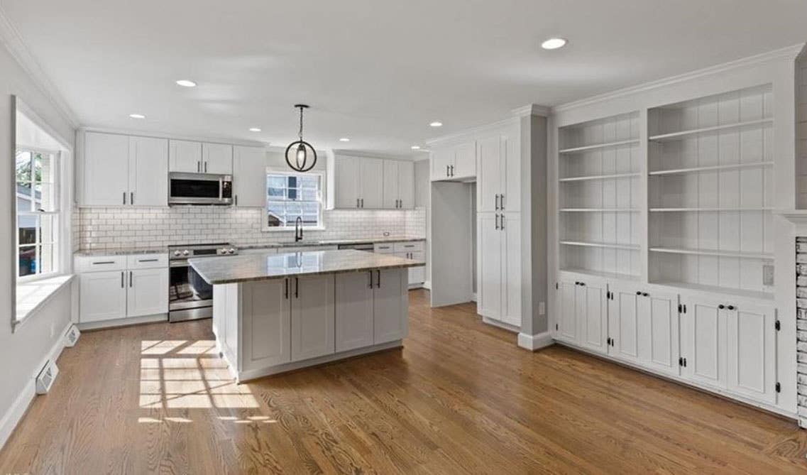 white modern kitchen design with kitchen cabinets, small island, open shelves, pendent light and SPC flooring 