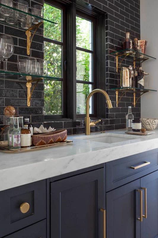 Modern kitchen with black subway tiles Backsplash and navy blue cabinets