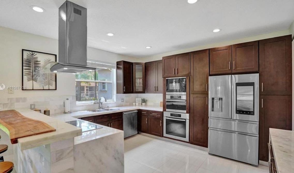 Tailored Luxury Kitchen with brown cabinets, marble waterfall countertop and stainless steel appliances 