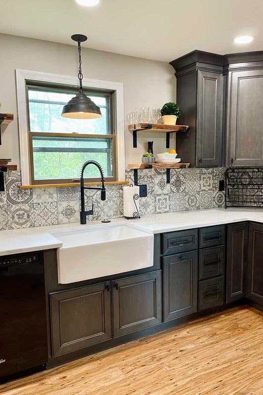 Terra Cotta Tiles backsplash paired with dark cabinets, white marble countertop and open shelves 