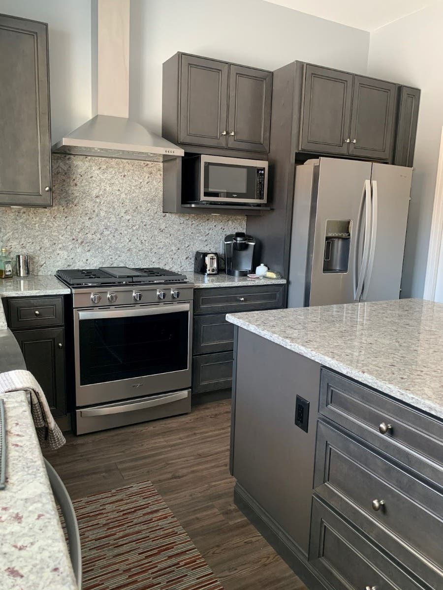 Textured Tiles backsplash paired with gray kitchen cabinets