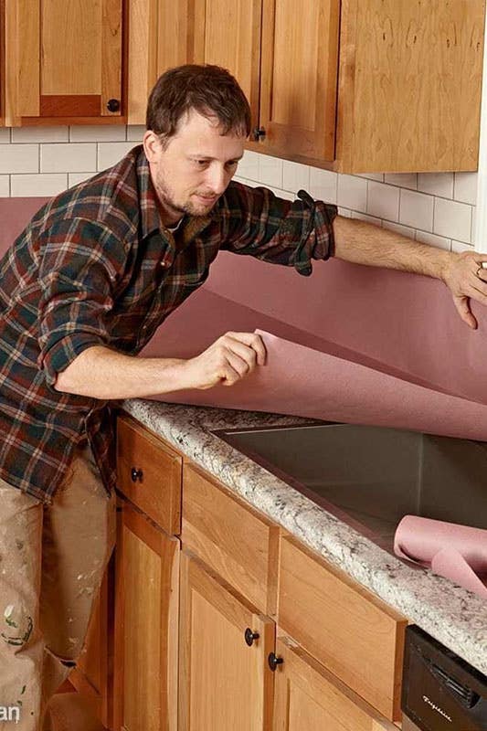 Man preparing kitchen for painting kitchen cabinets