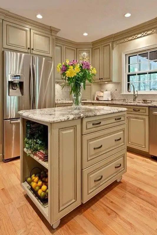 Traditional white cabinets with island, marble countertop and stainless steel appliances 