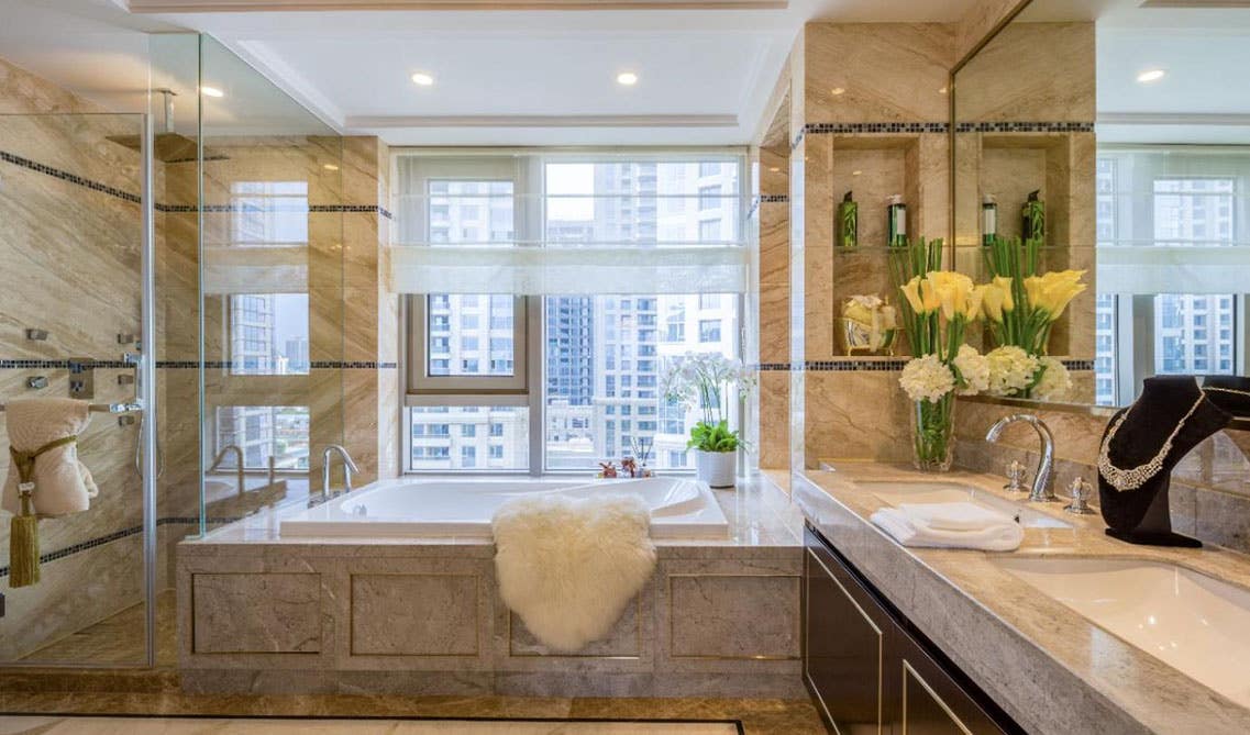 Traditional square Jacuzzi with glass door and double sink style cabinet top