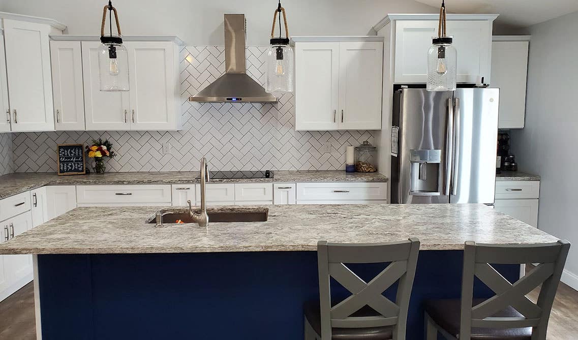 Traditional Herringbone Pattern subway tile paired with white cabinets