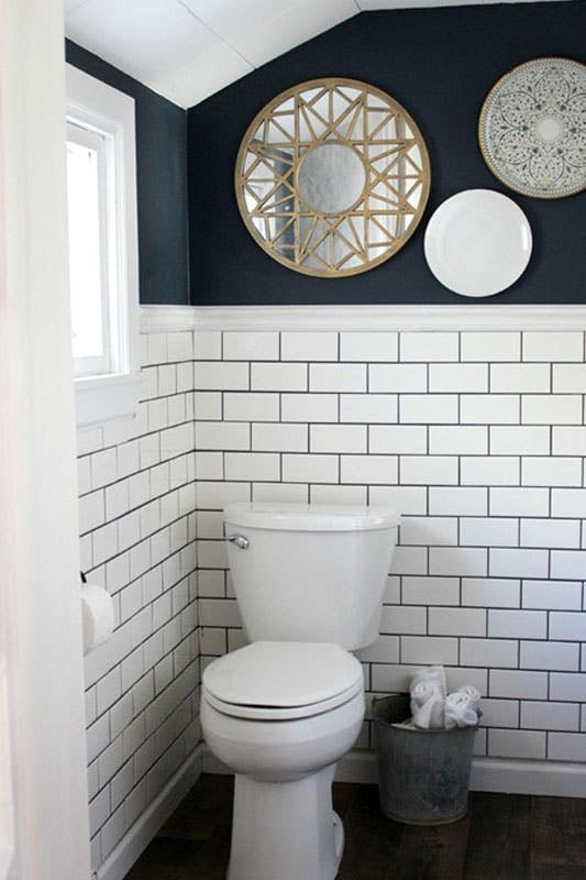 traditional bathroom remodel with navy wall paint, bohemian decor and traditional subway tile backsplash