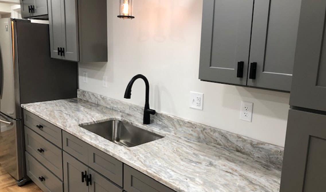 Travertine Countertops with gray cabinets