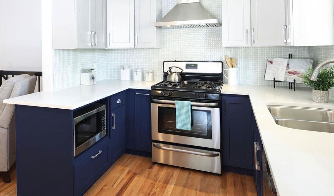 Two tone kitchen design with white and navy blue cabinets