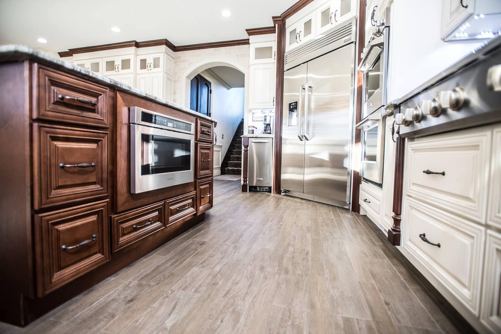 Traditional Kitchen with brown and white two tone cabinets