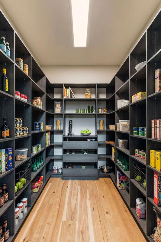 U-Shaped Walk In Pantry with Built-in Shelves stored with groceries