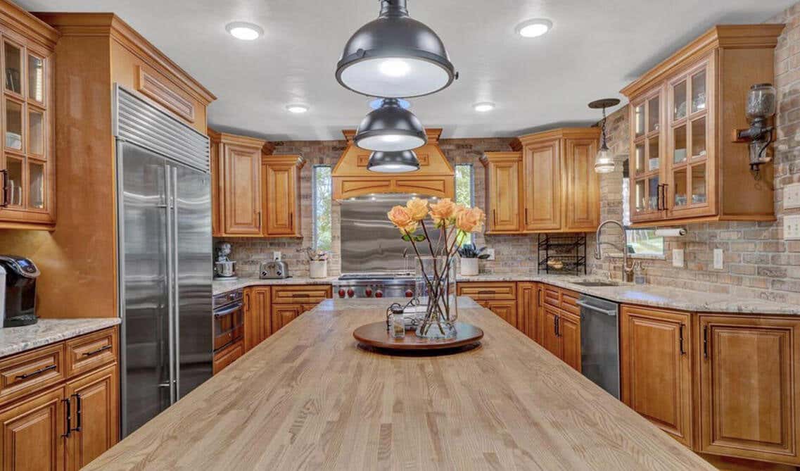 U shaped wood cabinets with butcher block countertop