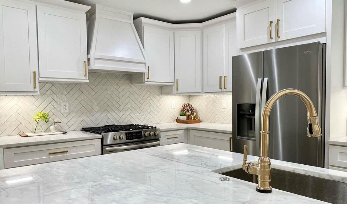 Modern kitchen style with white cabinets, functional island and under cabinet lighting