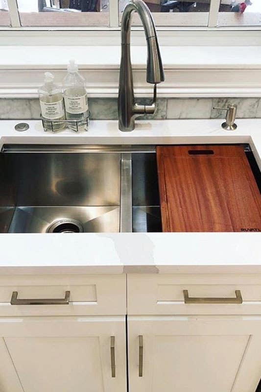 Undermount stainless steel kitchen sink with white shaker base cabinets