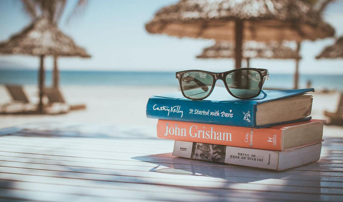 Vacation picture of books and sunglass 