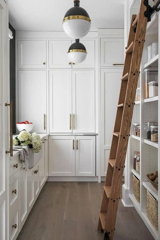 Walk In Pantry with Sliding Ladder and white cabinets