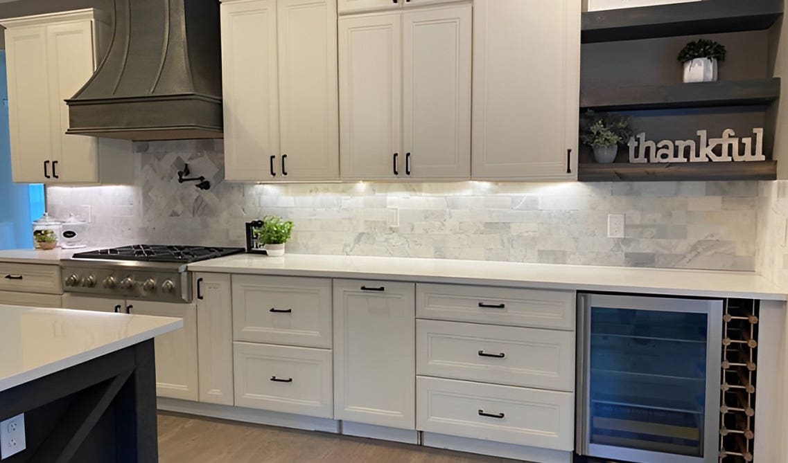 white shaker cabinets paired with black hardware, black Hoods, white countertop and under cabinet light 
