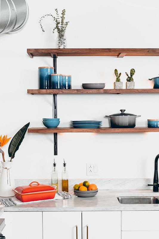 Farmhouse kitchen features White Base Cabinets With Wooden Open Shelving and white marble countertops