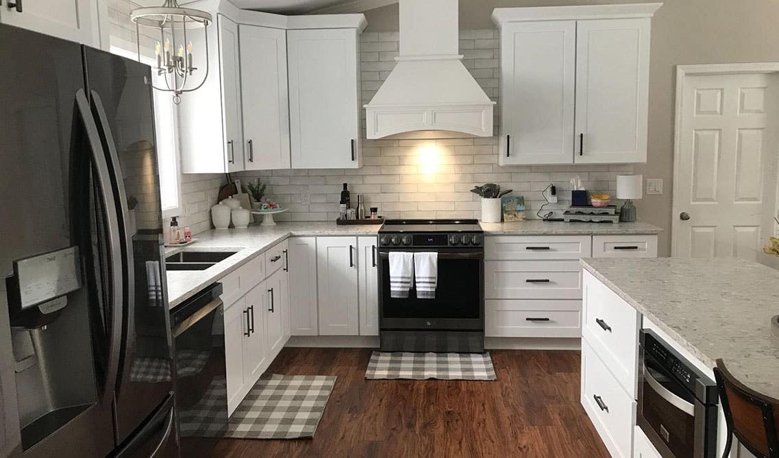 White Brick Backsplash with marble Countertop and bright white cabinets