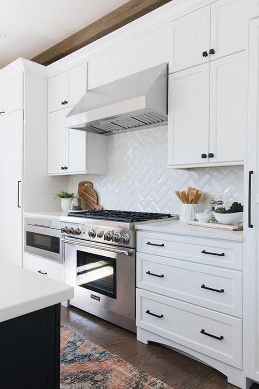 White Brick Backsplash with bright white cabinets and Stainless Steel Appliances