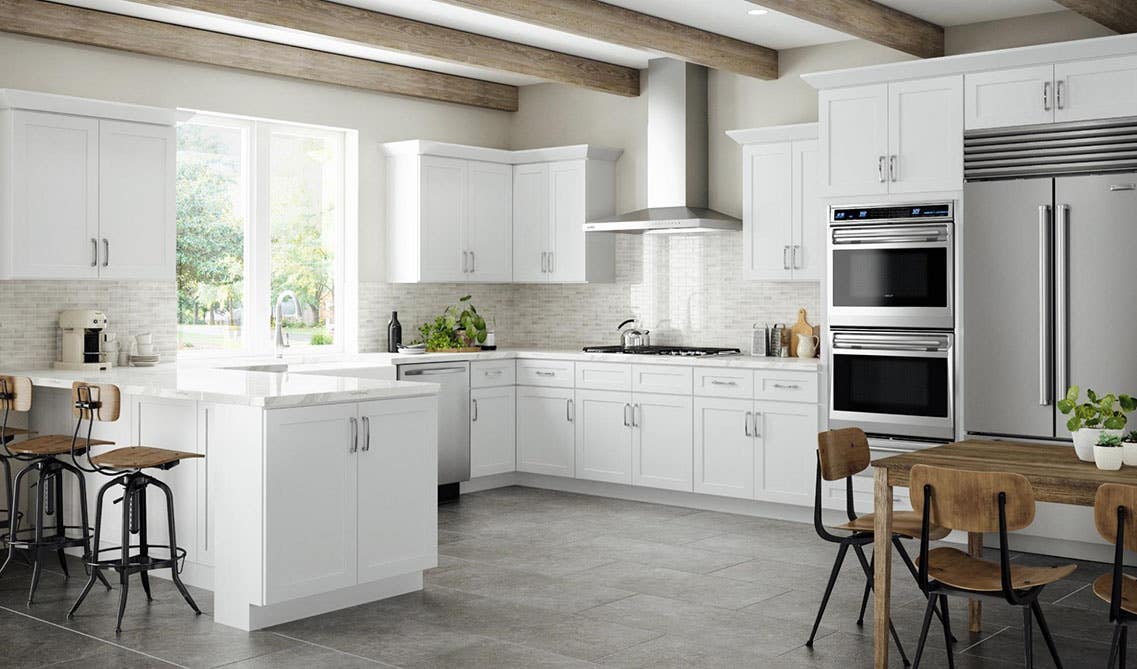 Airy kitchen with white cabinetry, and marble countertop