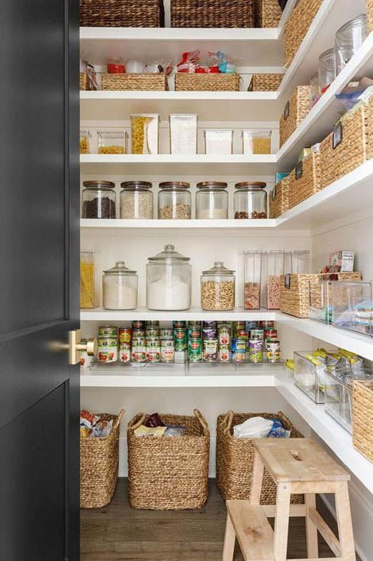 Walk In Pantry with White Built-in Shelves stored with containers and baskets