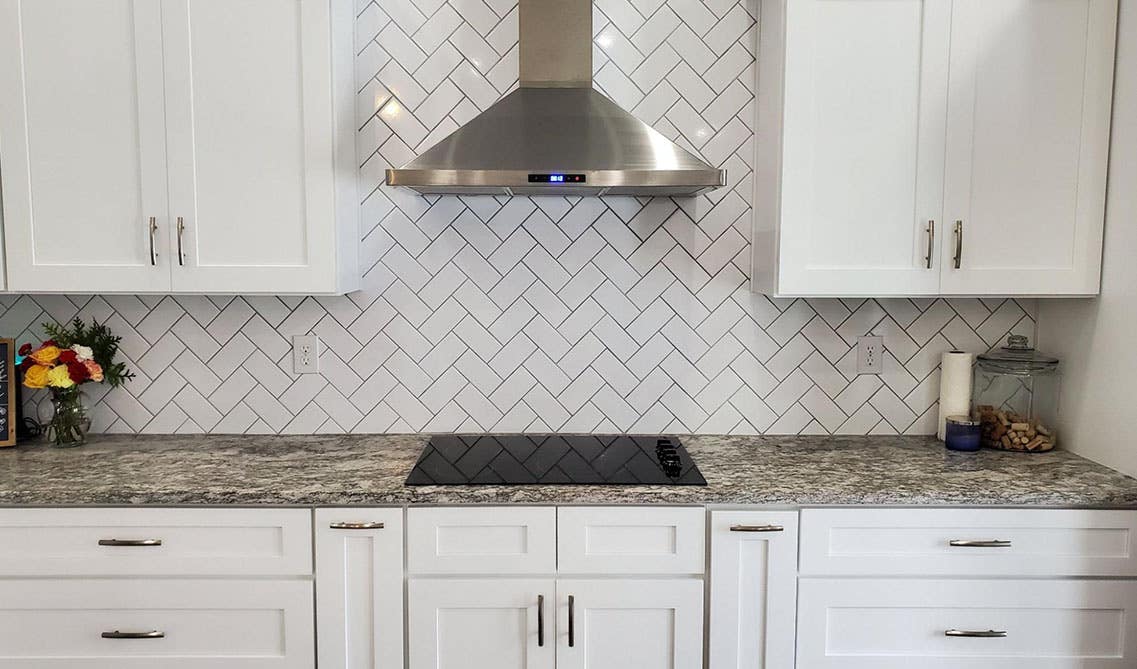 Modern kitchen with White Herringbone tiles Backsplash and shaker cabinets