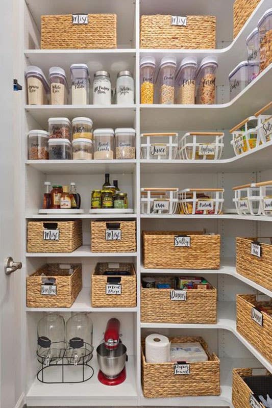 Walk In Pantry with White floating Shelves stored with containers and baskets